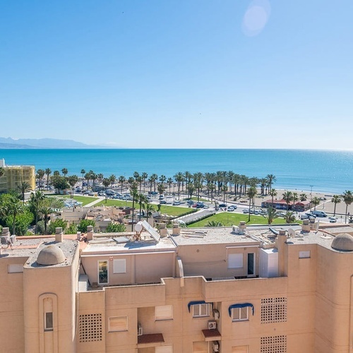 a view of the ocean from a balcony of a building