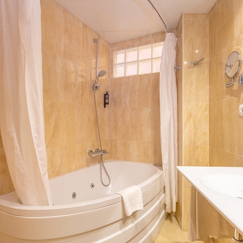 a bathroom with a jacuzzi tub and a sink