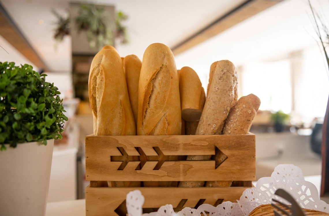 a wooden box filled with bread has an arrow carved into it