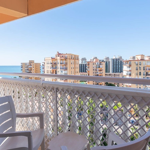 a balcony with a view of the ocean and buildings