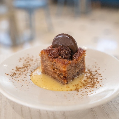 a white plate with a piece of cake on it