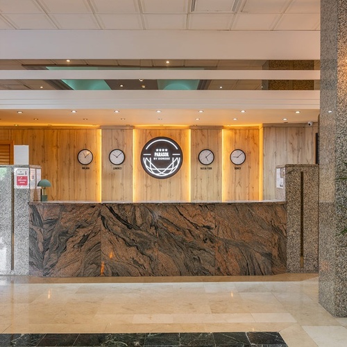 a hotel lobby with clocks and a sign that says hotel