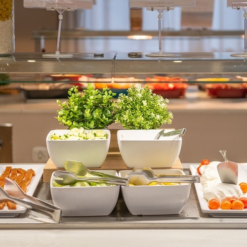 un buffet lleno de platos de comida y plantas