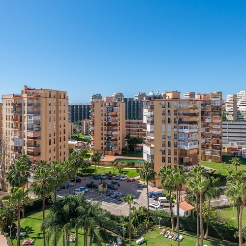 an aerial view of a city with lots of buildings and palm trees