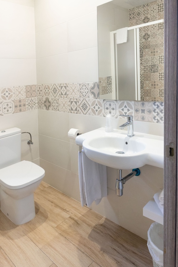a bathroom with a sink toilet and mirror