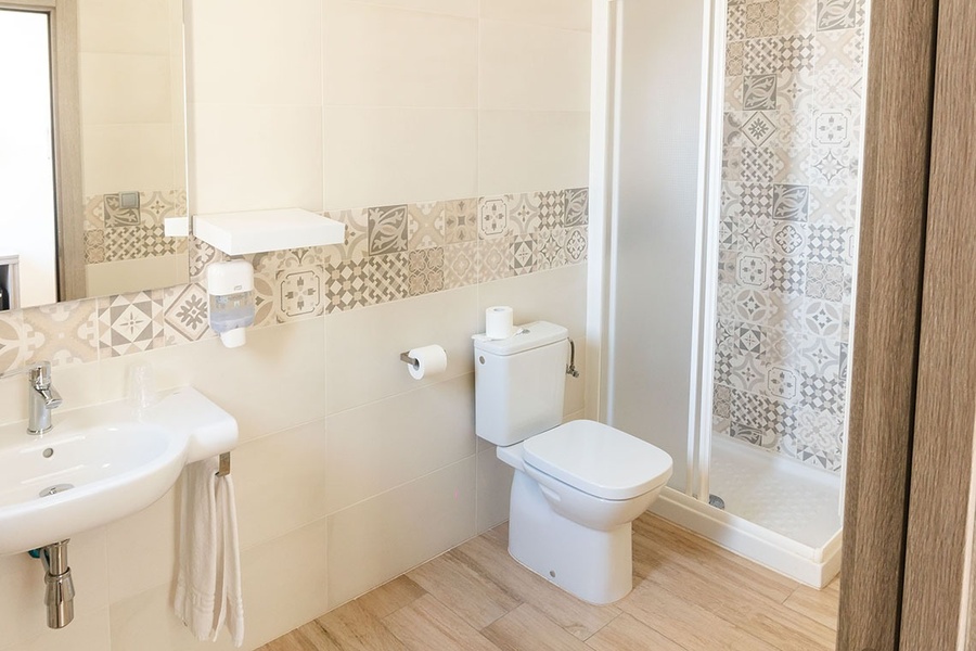 a bathroom with a toilet a sink and a shower