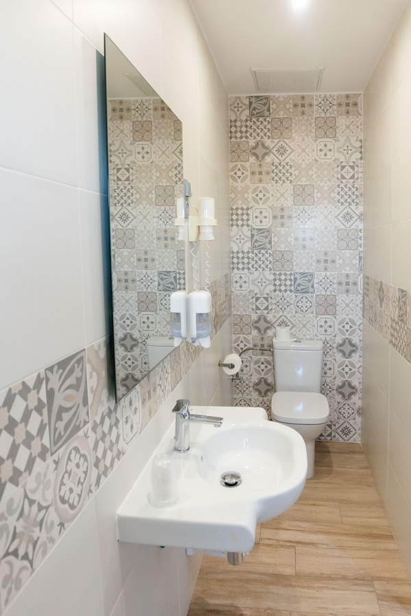 a bathroom with a sink and toilet and a mirror