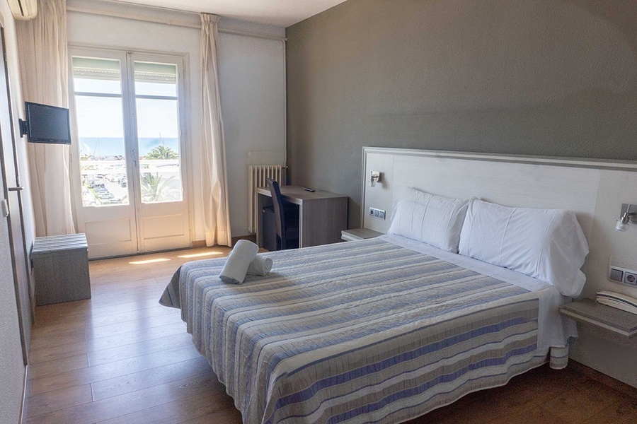 a hotel room with a bed and a television