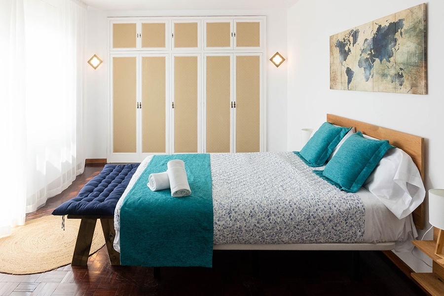 a bedroom with a map of the world on the wall above the bed