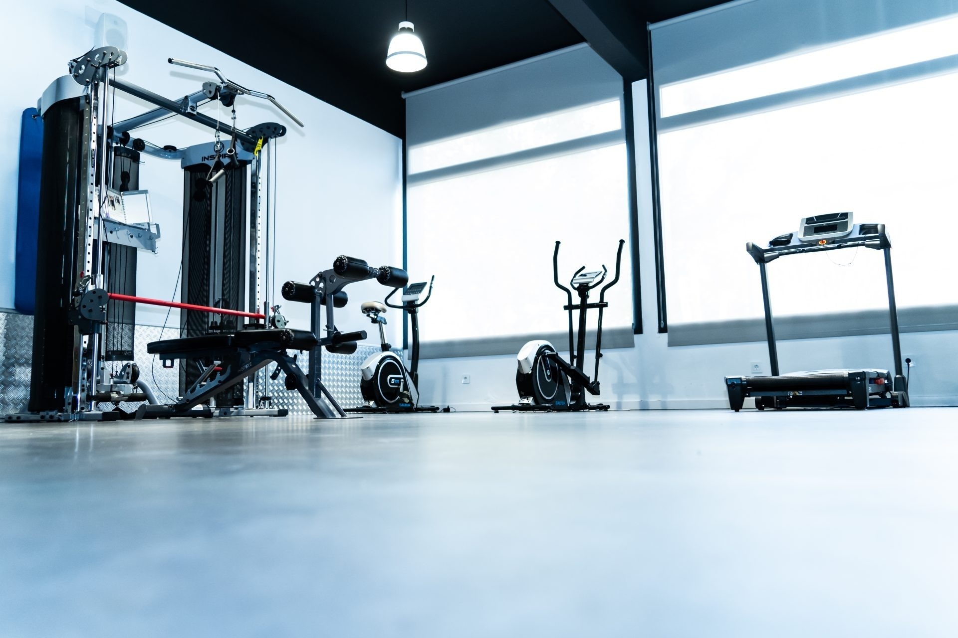 un gimnasio vacío con una bicicleta y una cinta de correr