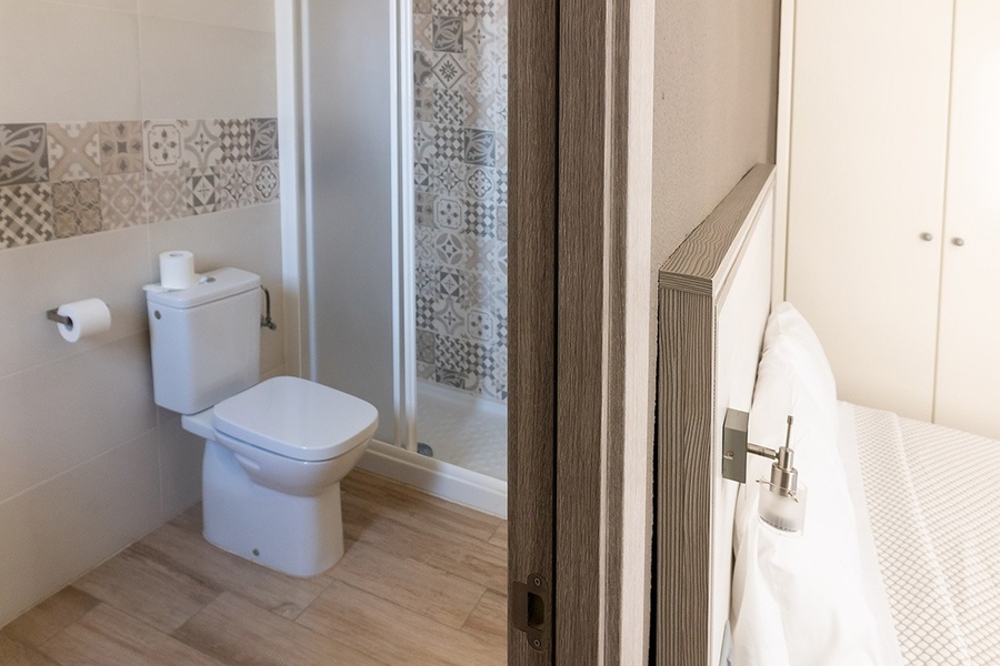 a bathroom with a toilet and a walk in shower