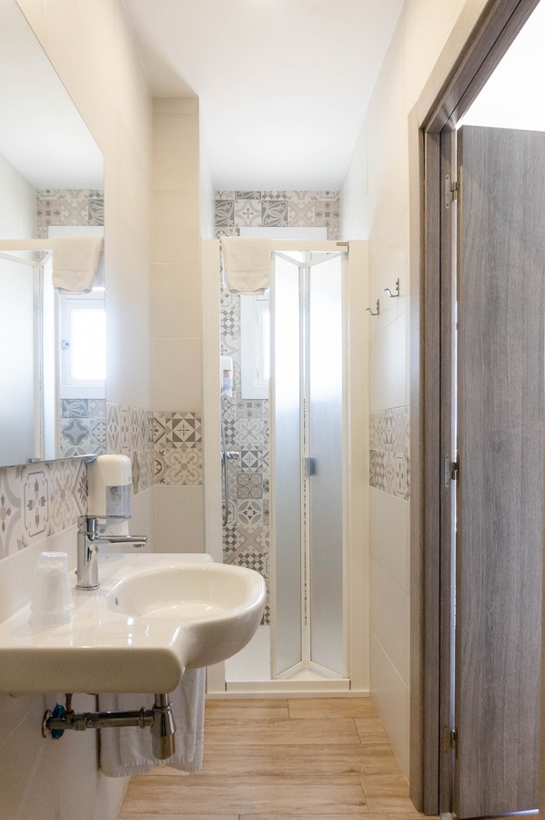 a bathroom with a sink and a walk in shower