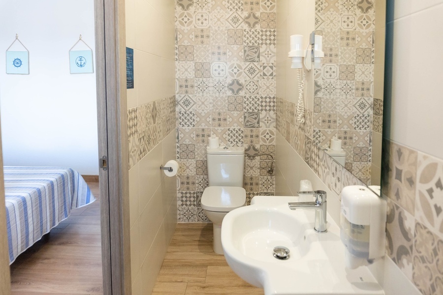 a bathroom with a sink toilet and mirror