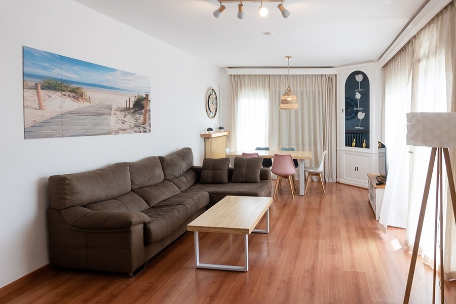 a living room with a couch and a picture on the wall