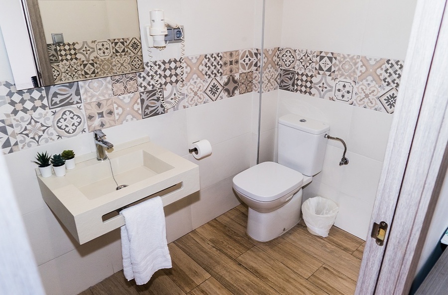 a bathroom with a toilet a sink and a mirror