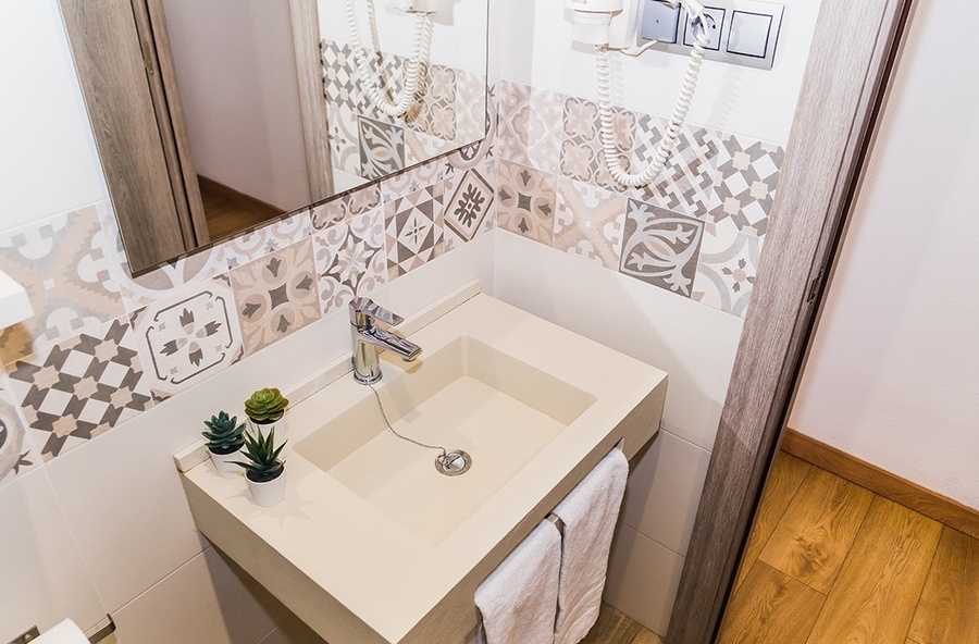 a bathroom with a small sink and a mirror