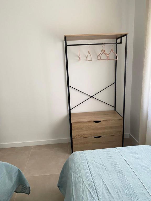 Open wardrobe with drawers and hanging rail at Hotel Planas.