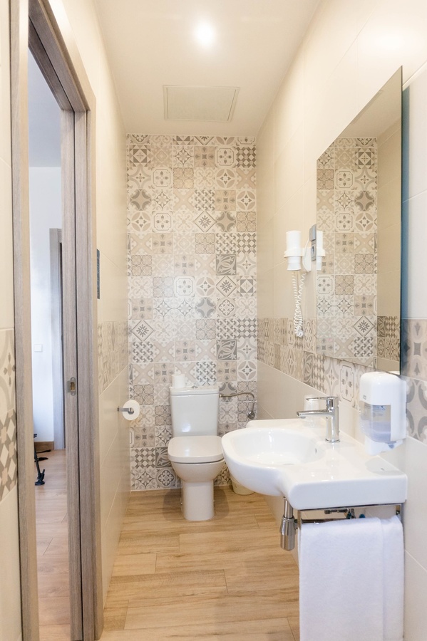 a bathroom with a toilet a sink and a mirror