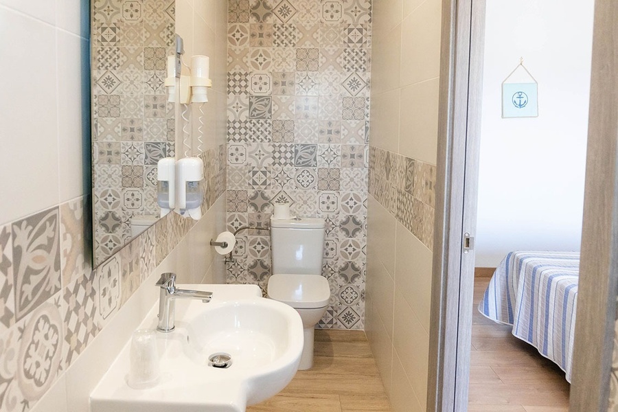 a bathroom with a sink toilet and mirror