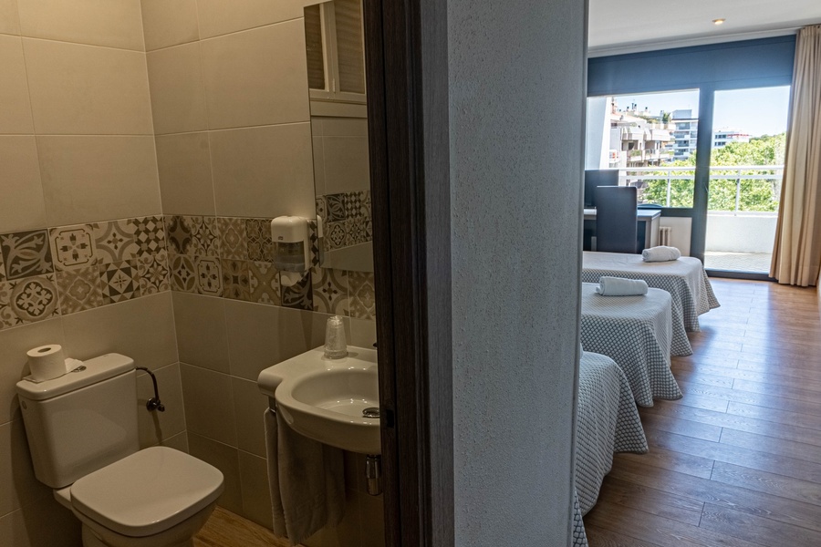 a bathroom with a toilet a sink and a mirror