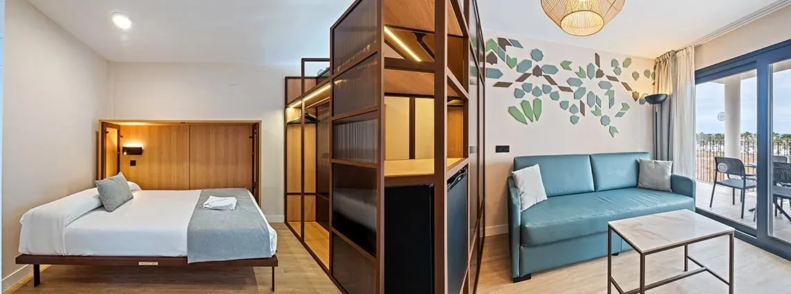 Modern room at Hotel Puente Real ****, Torremolinos: bed, sofa, and balcony.