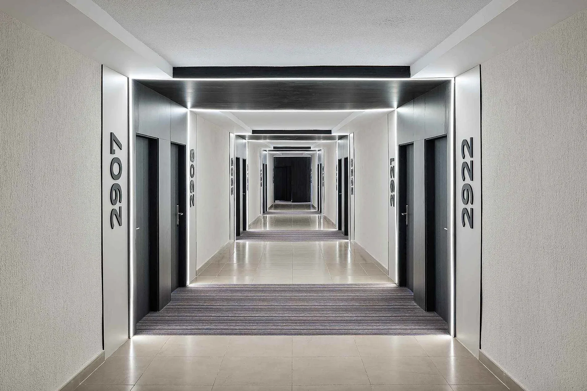 Modern hotel corridor at Puente Real, Torremolinos, with LED lighting.