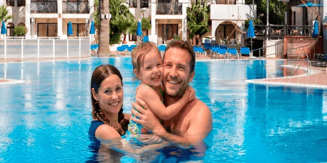 Happy family swimming in hotel pool. <p>	Hotel Puente Real ****, Torremolinos</p> vacation memories.