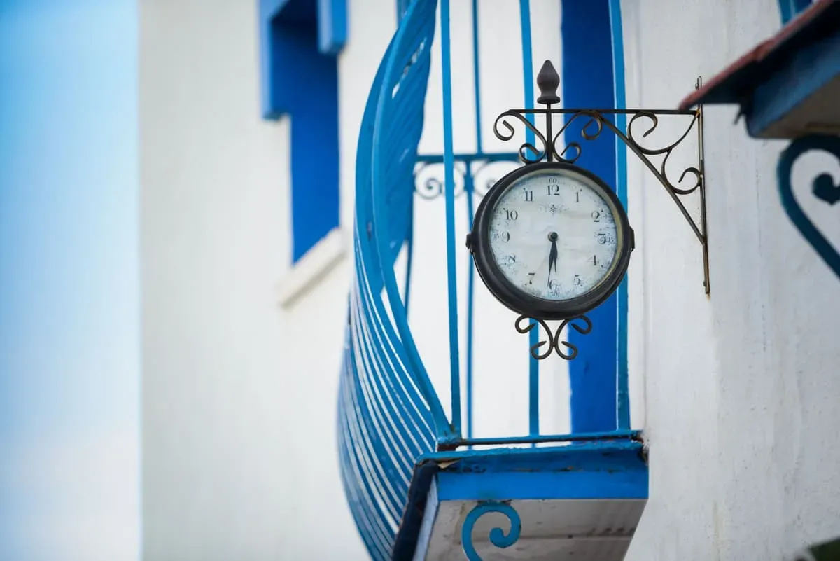 Antique clock on the blue balcony of the Hotel Puente Real ****