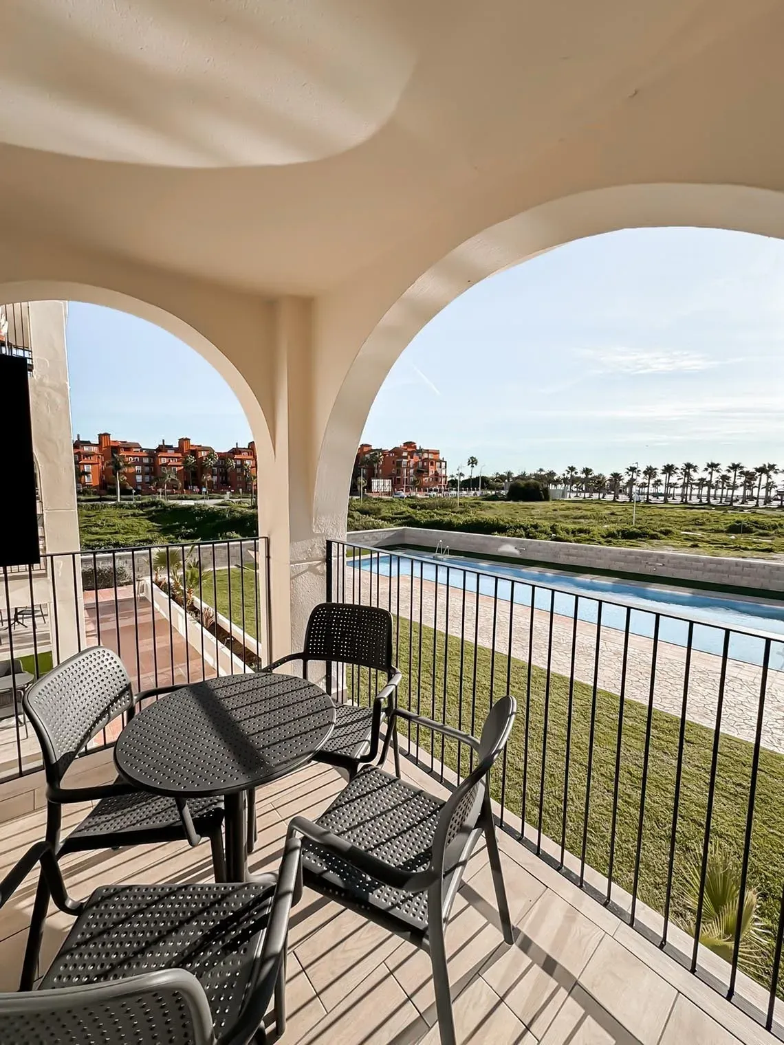 Balcony with table & chairs overlooking pool at Hotel Puente Real ****, Torremolinos.