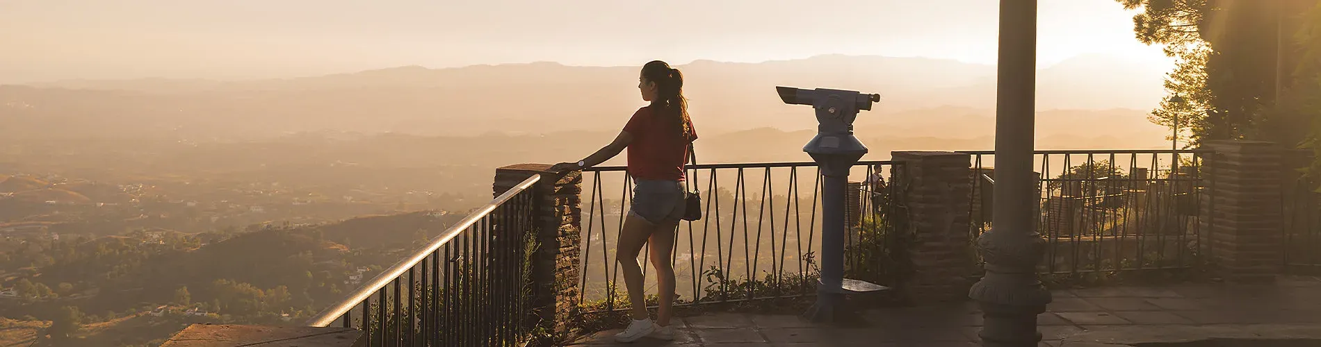 Woman enjoying sunset view from hotel balcony <p>	Hotel Puente Real ****, Torremolinos</p>.