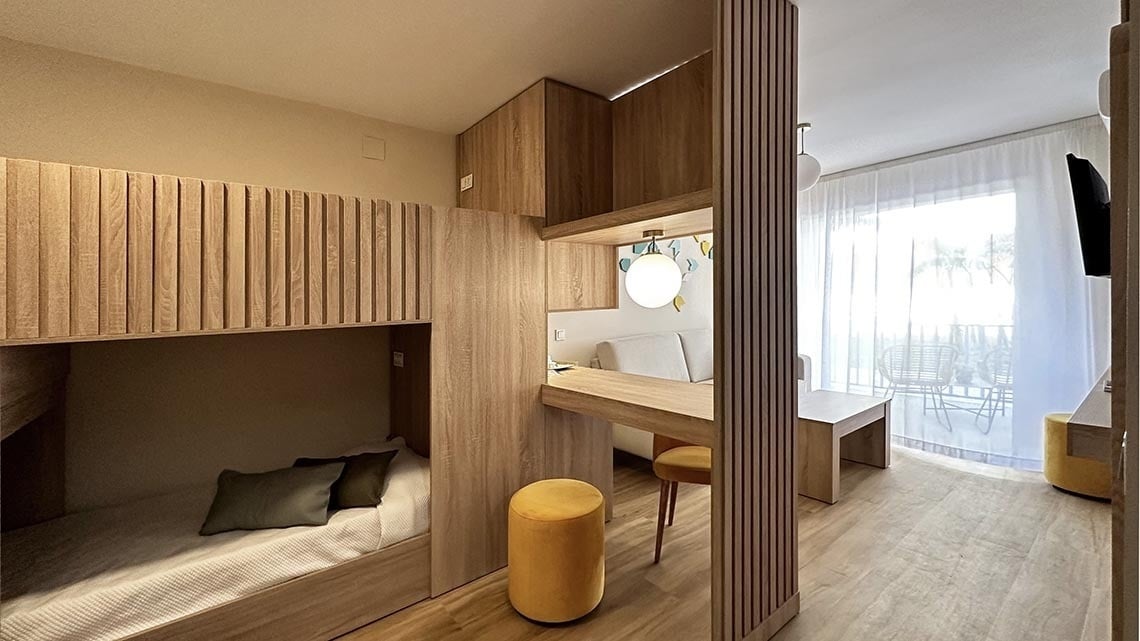 a bedroom with bunk beds and a desk