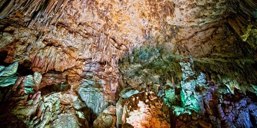 a large cave filled with lots of rocks and stalagmites .