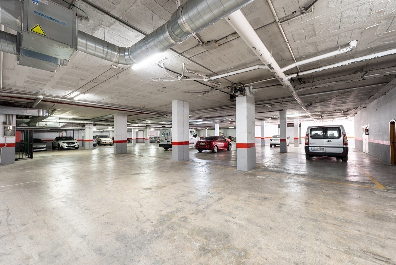 a white van is parked in a parking garage