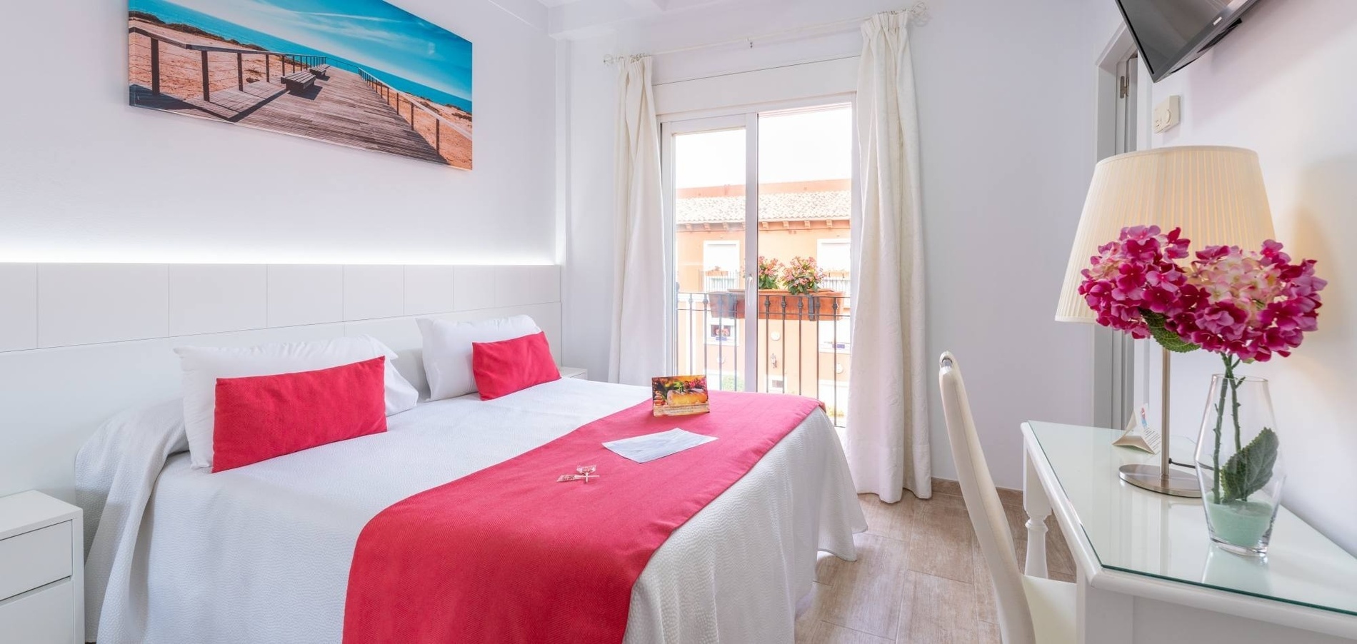 a hotel room with two beds and a lamp