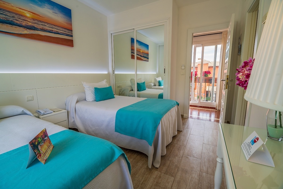 a hotel room with two beds and a sign that says " welcome "