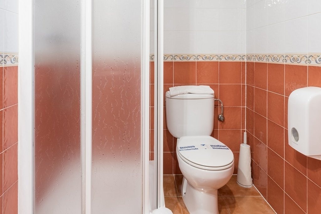 a bathroom with a toilet and a shower stall