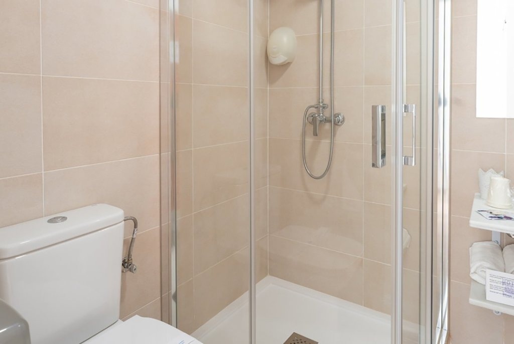 a bathroom with a toilet and a shower stall