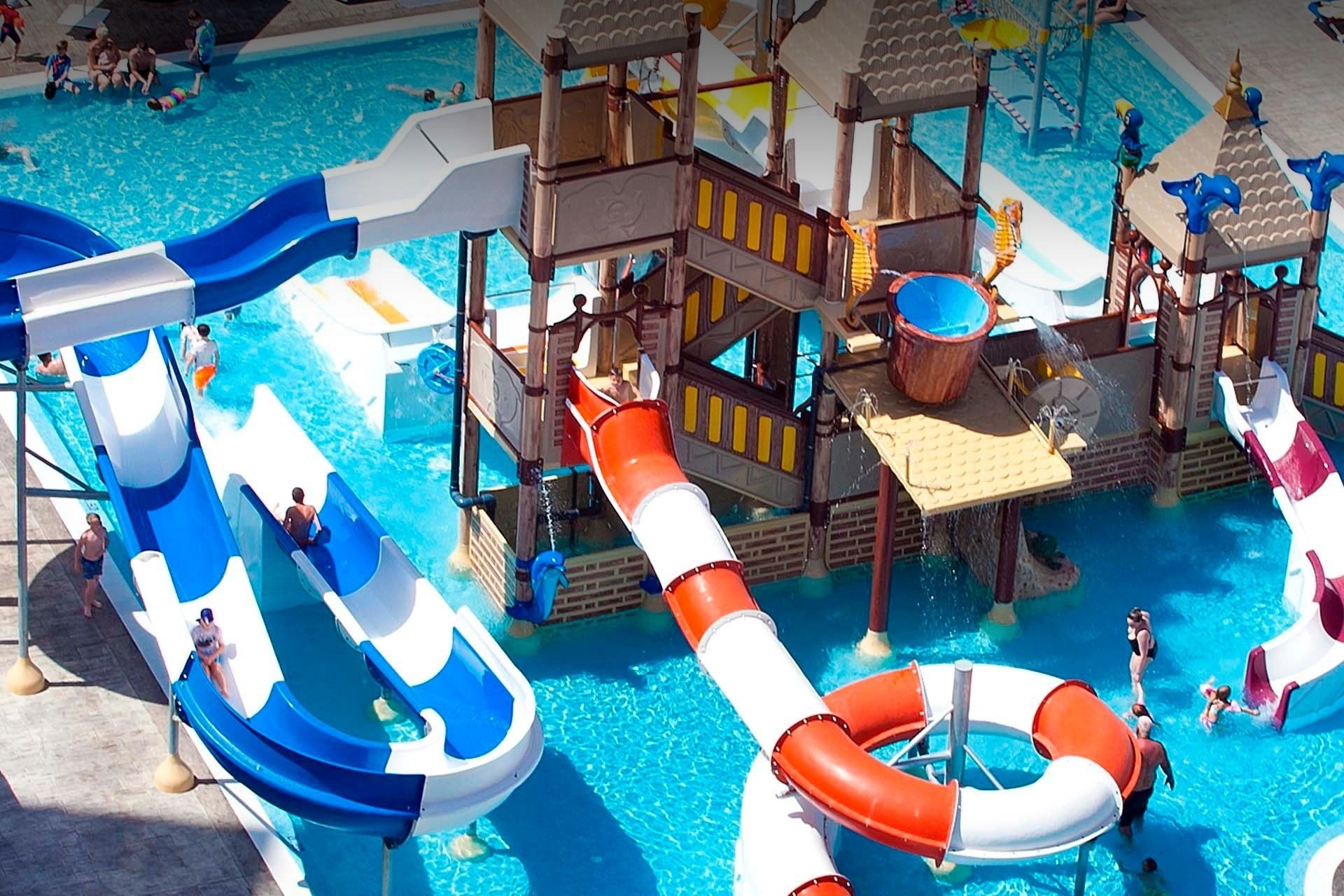 a group of people are playing in a water park