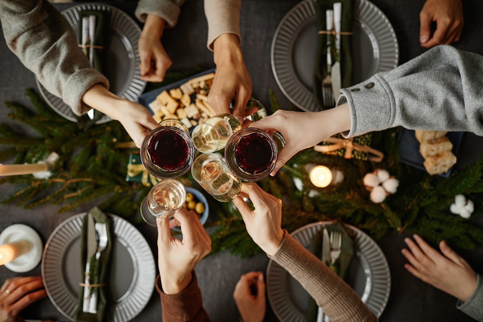 a group of people toasting with wine glasses