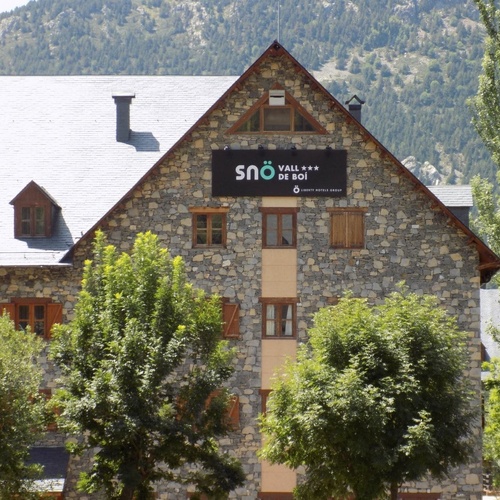 a stone building with a sign that says sno