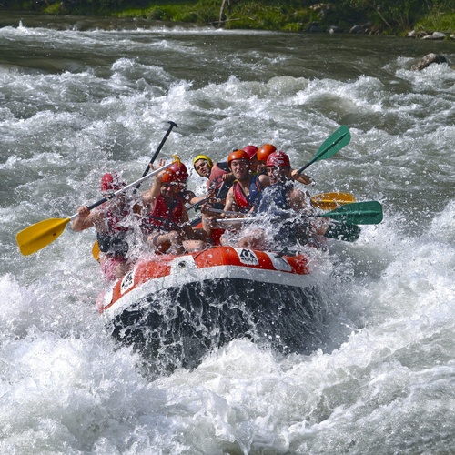 a group of people are rafting down a river and one of the rafts has the number 48 on it