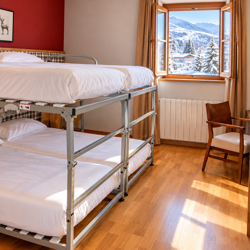 Triple family room with bunk beds at SNO: Hotel Vall de Boi.