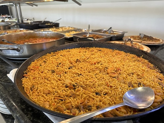 a pan of rice with a spoon in it