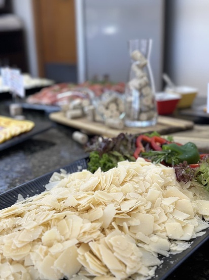 a plate of sliced cheese sits on a table