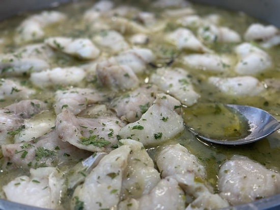 a close up of a pot of food with a spoon in it