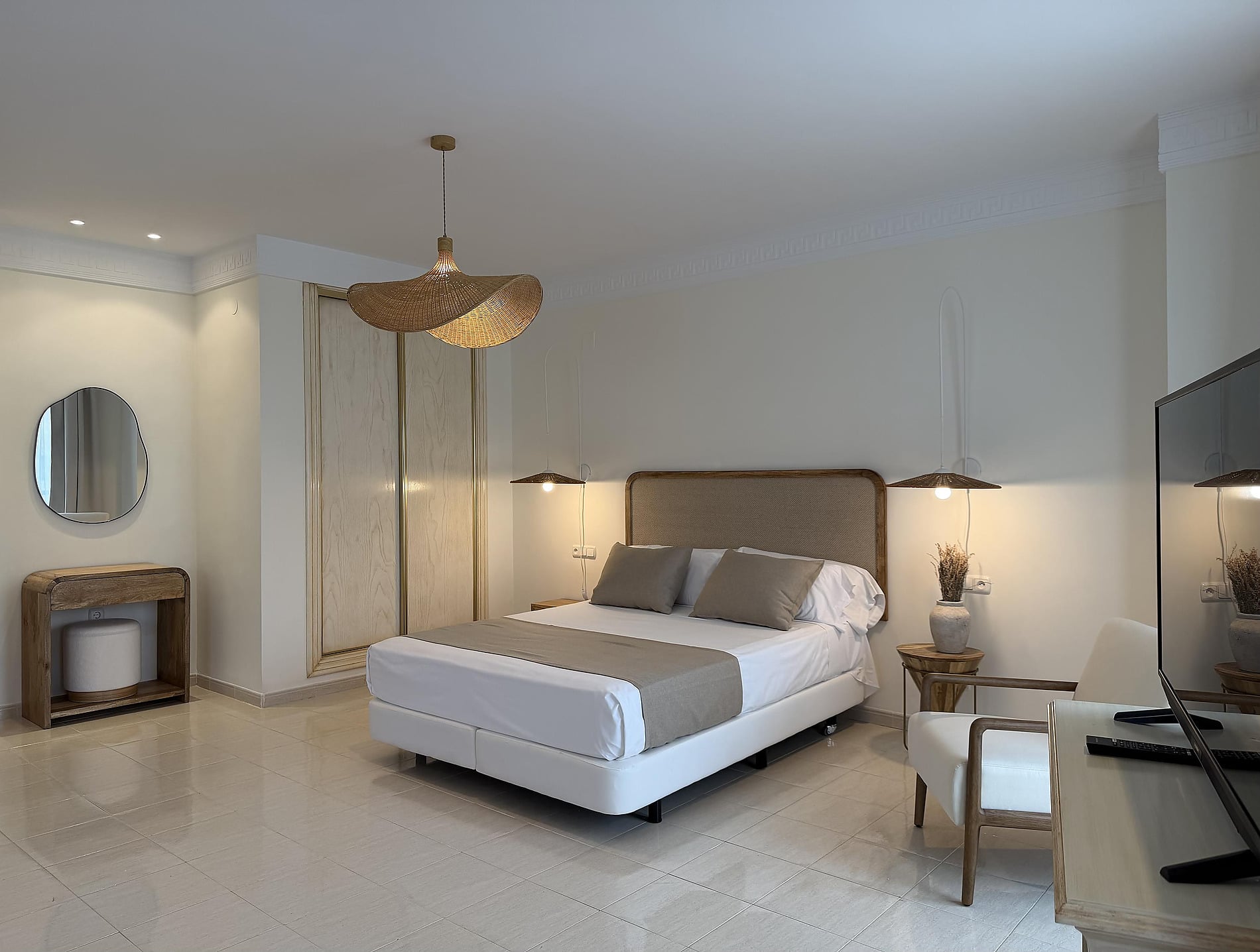 A modern hotel bedroom featuring a king-size bed, woven lamps, and a stylish mirror for Rooms | Hotel Victoria Playa in Almunecar | Official Web comfort.