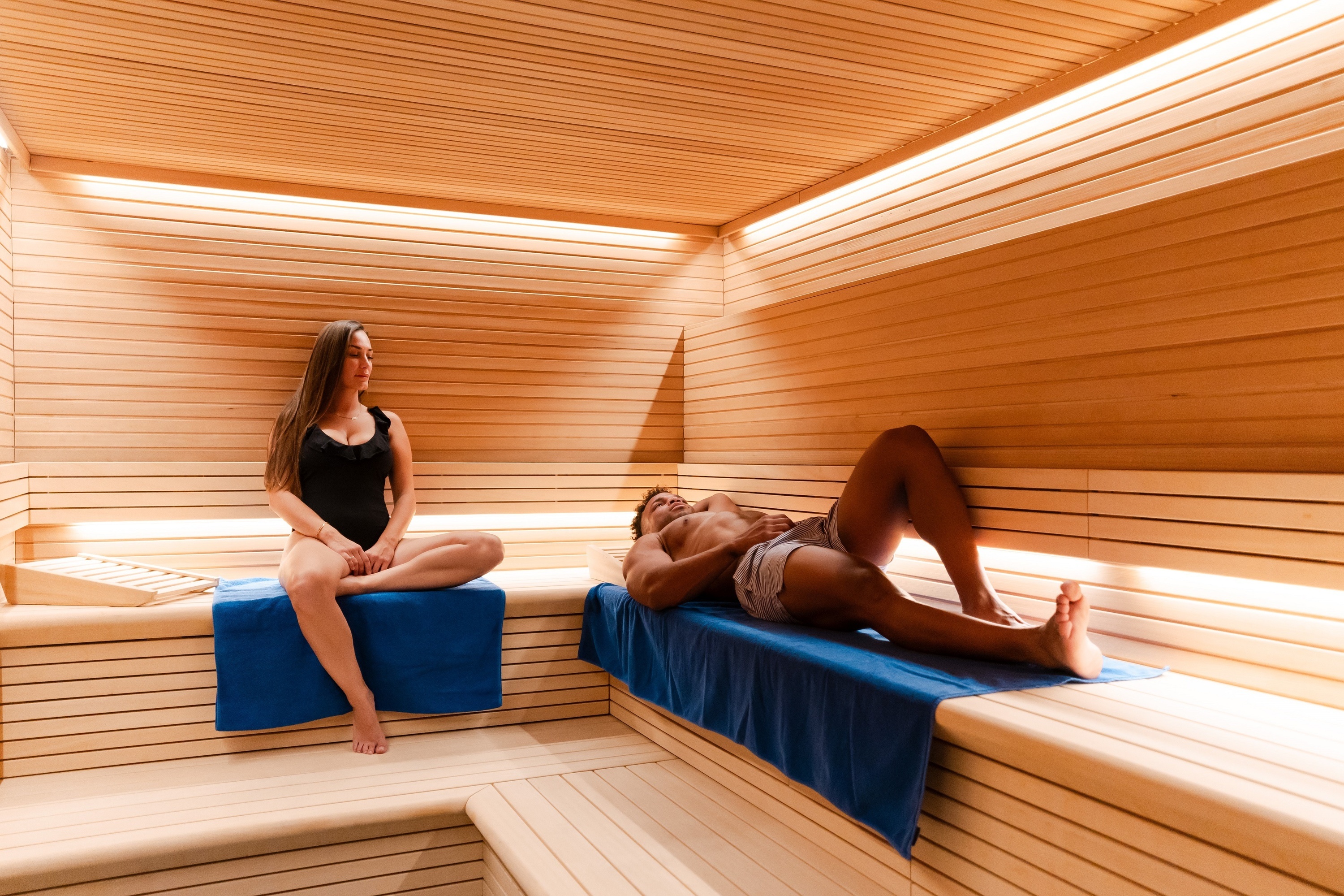 
                                    a woman sits in a chair reading a book called the sea spa