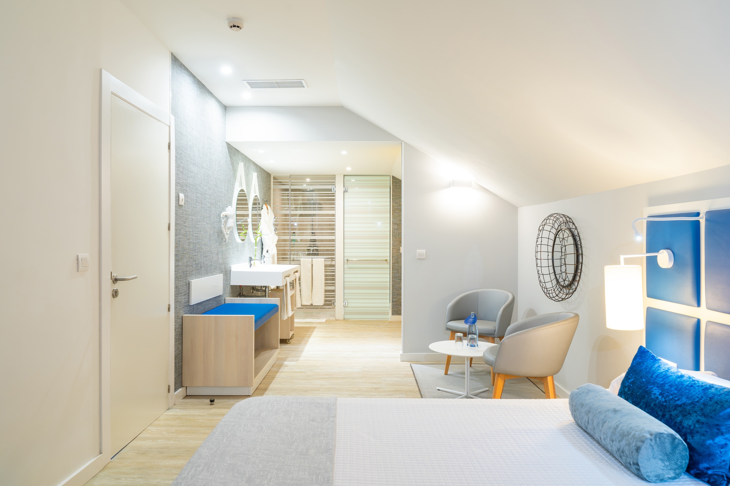 a hotel room with a large bed and chairs