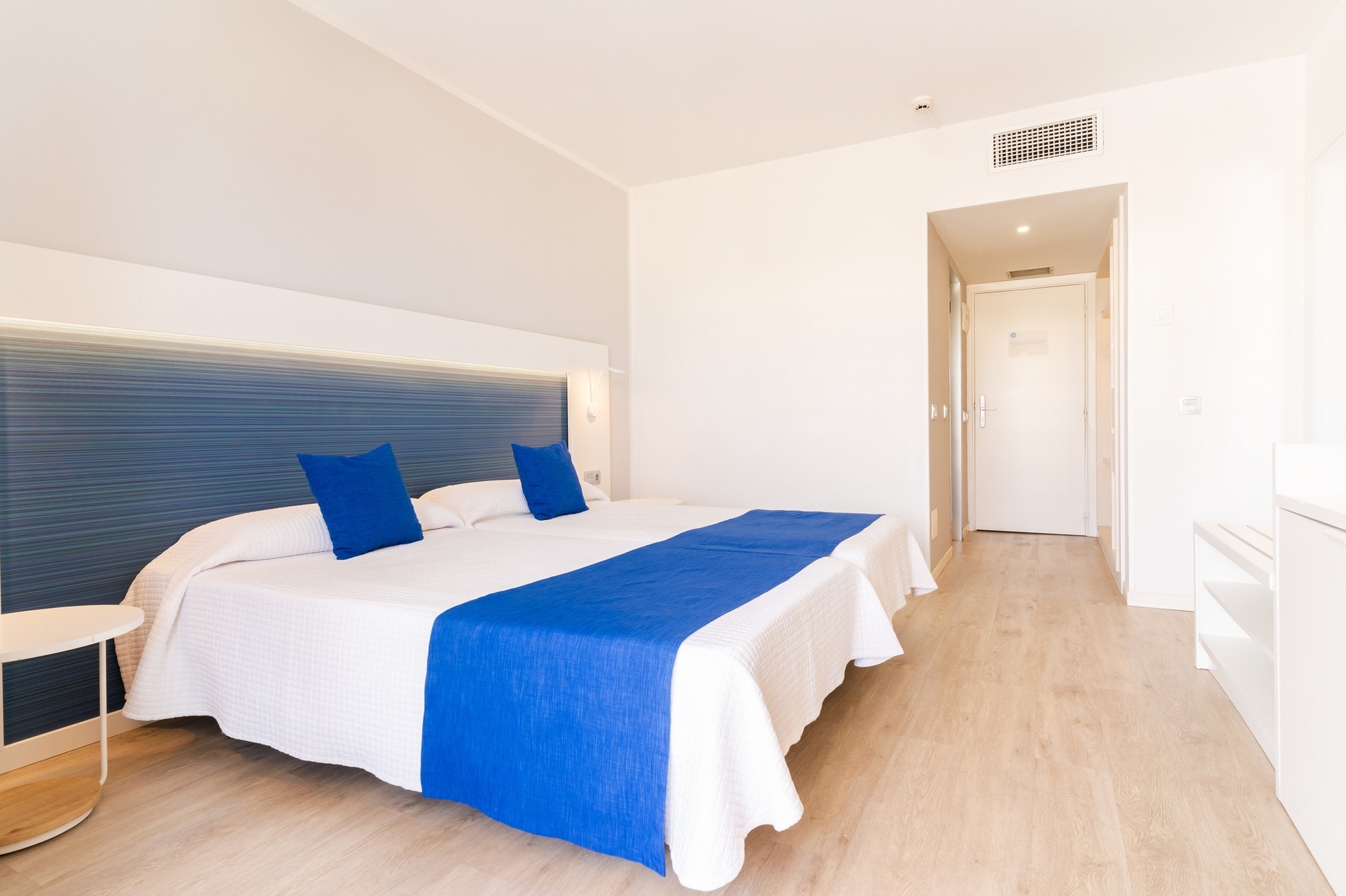 a hotel room with two beds and a television