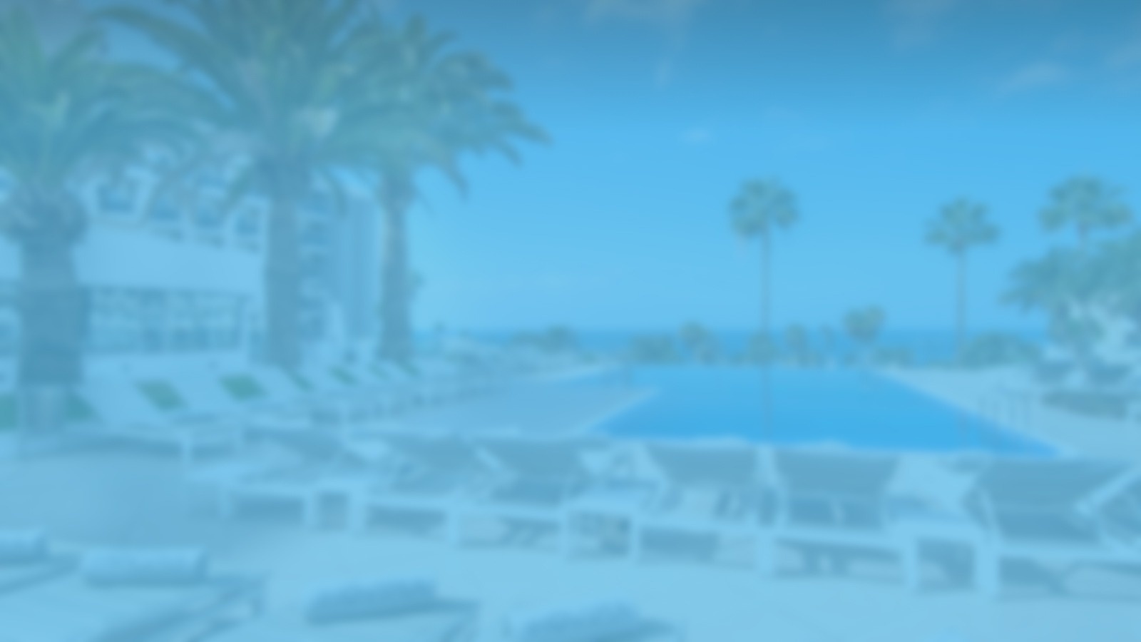 a blurry picture of a swimming pool with palm trees in the background .